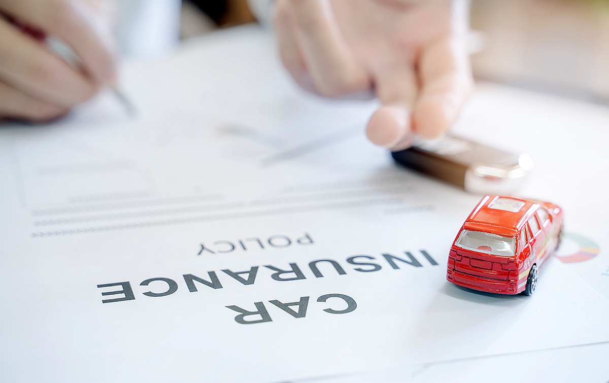 a person signing auto insurance policy paperwork