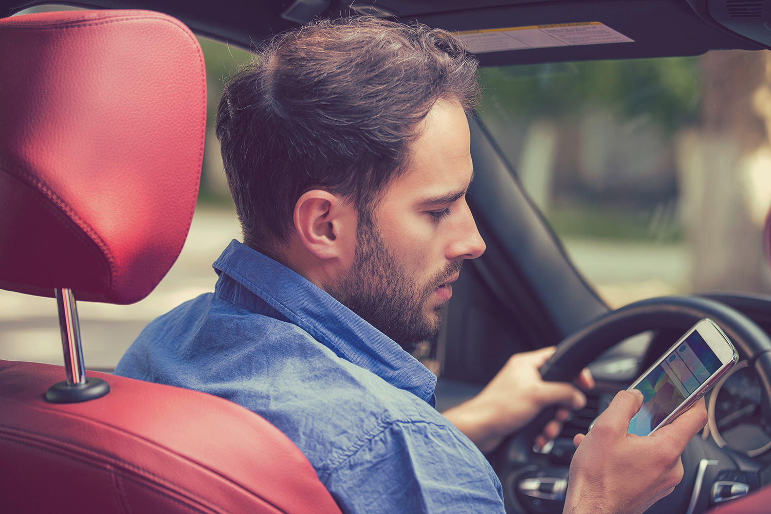 a driver using their phone and not paying attention to the road