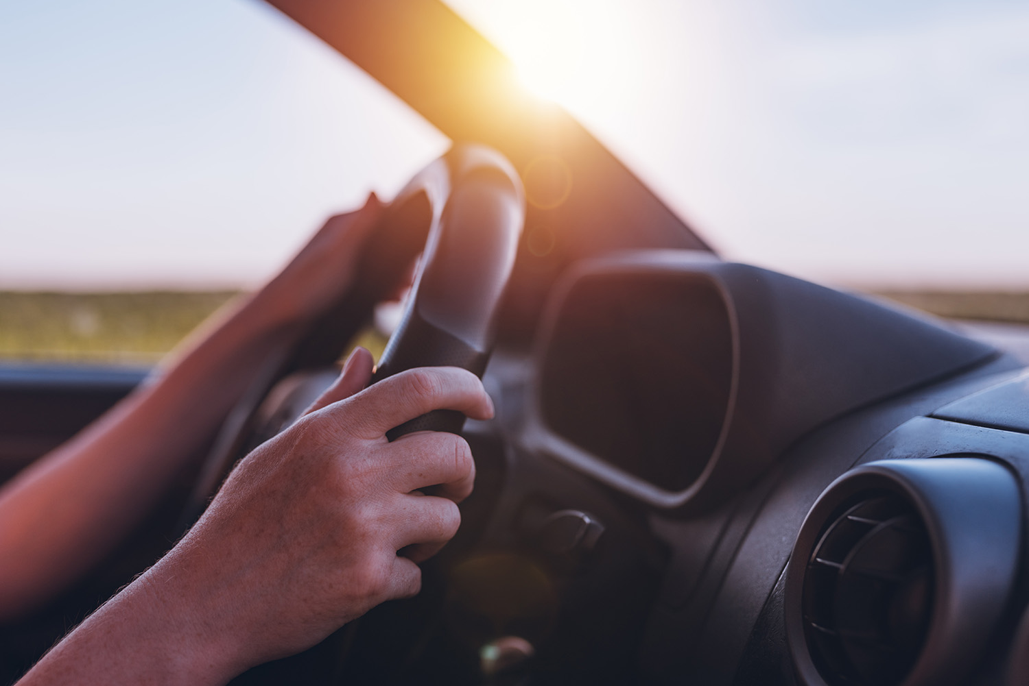 a person driving on a particularly sunny day