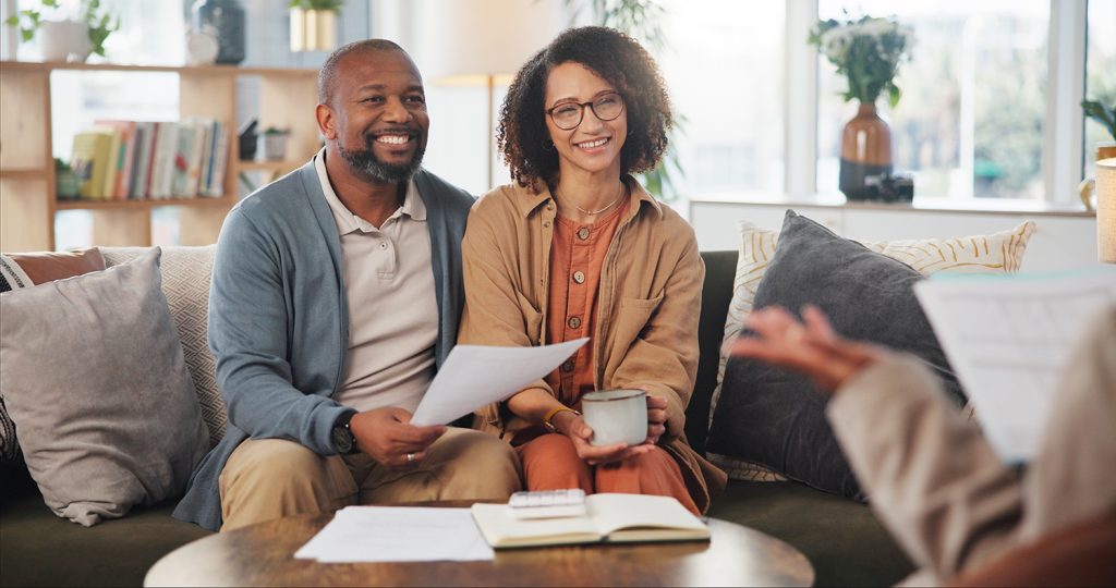 a couple sitting together and smiling while they plan