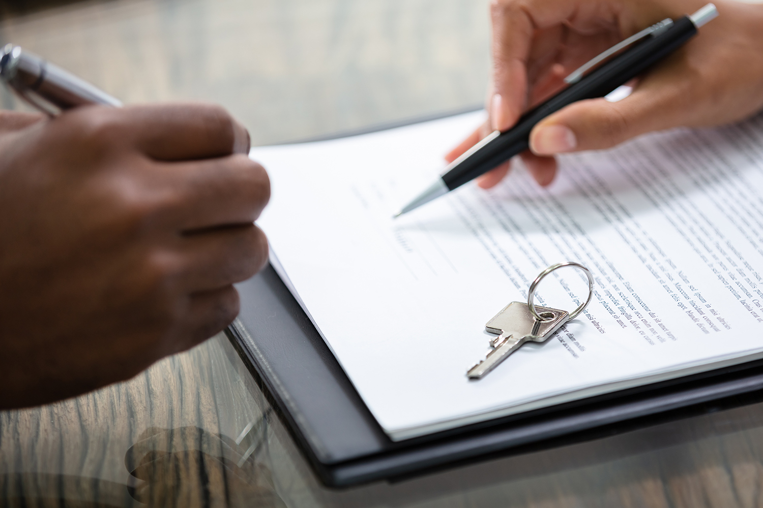 A person signing real estate paperwork.